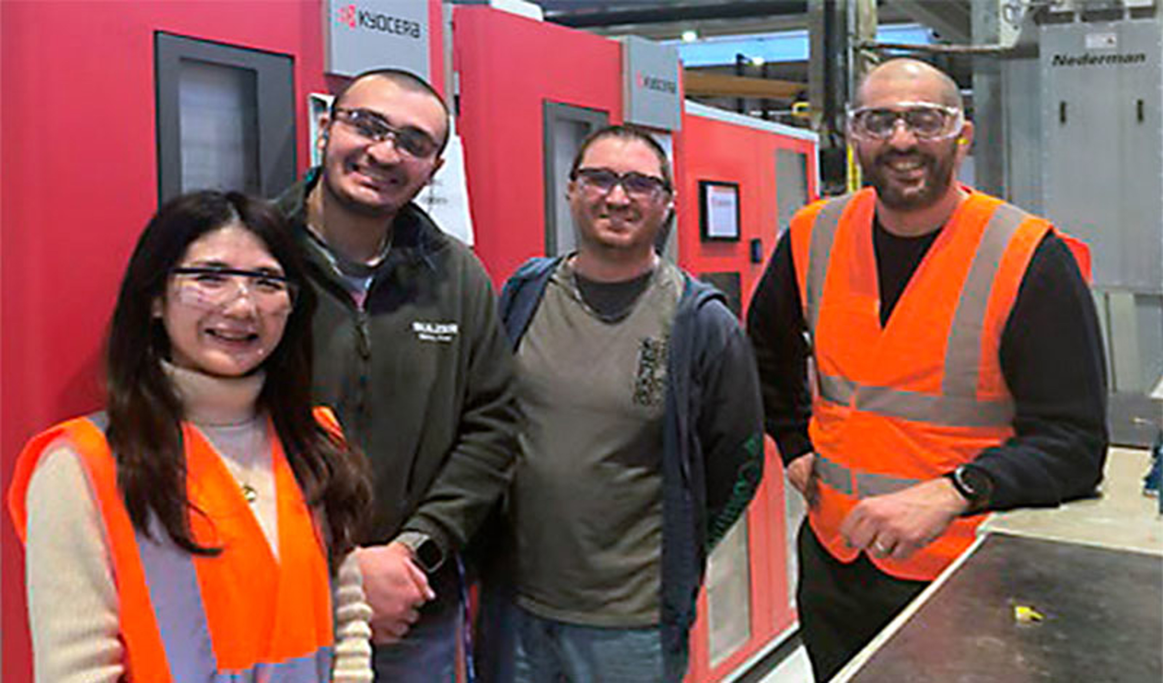 Four people in front of a management tooling system 